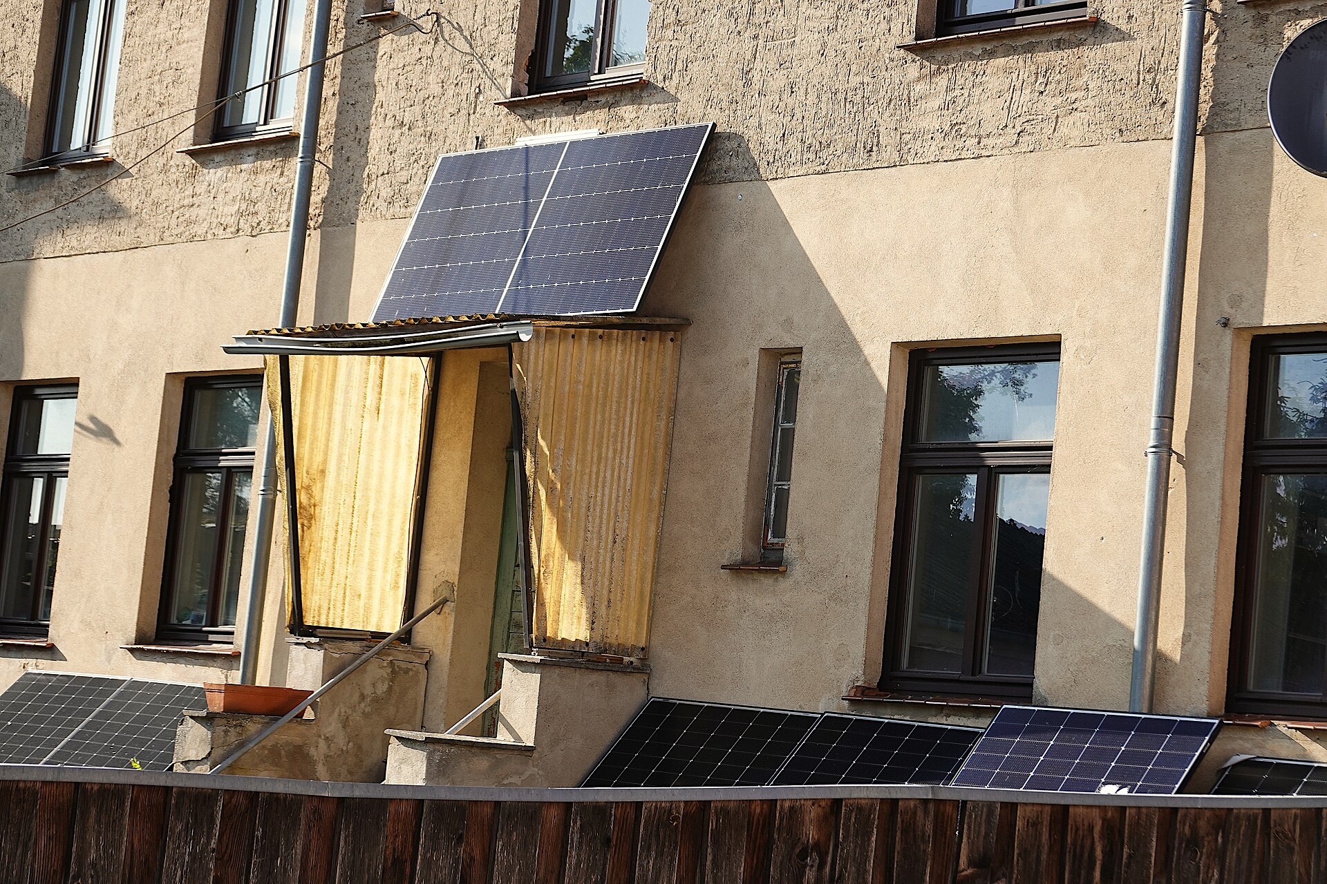 Panneaux solaires fixés à la façade et au balcon d'un immeuble résidentiel
